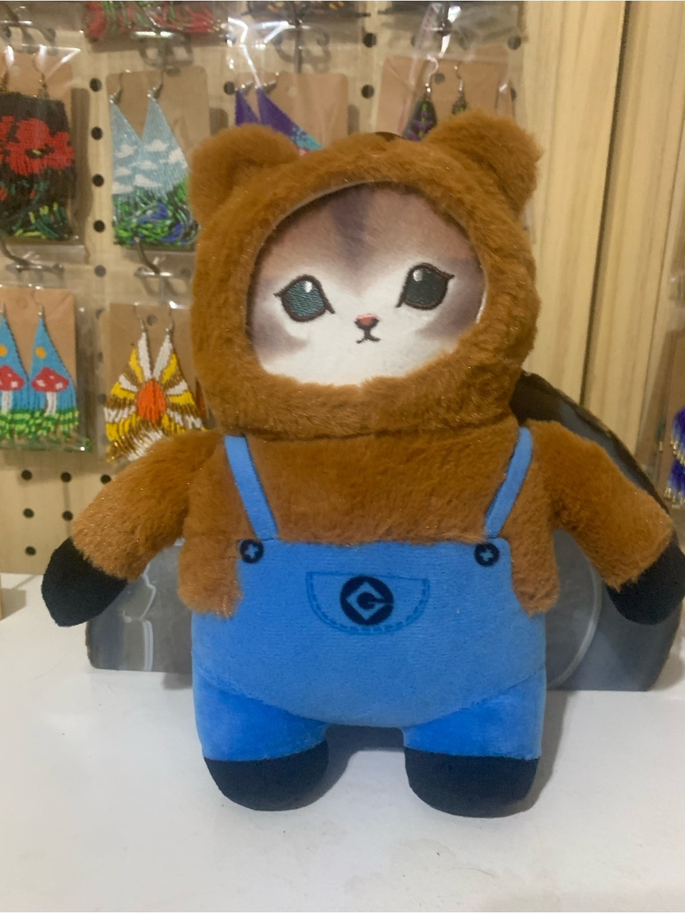 Mofusand Kawaii Cat dressed in a bear costume and blue overalls.